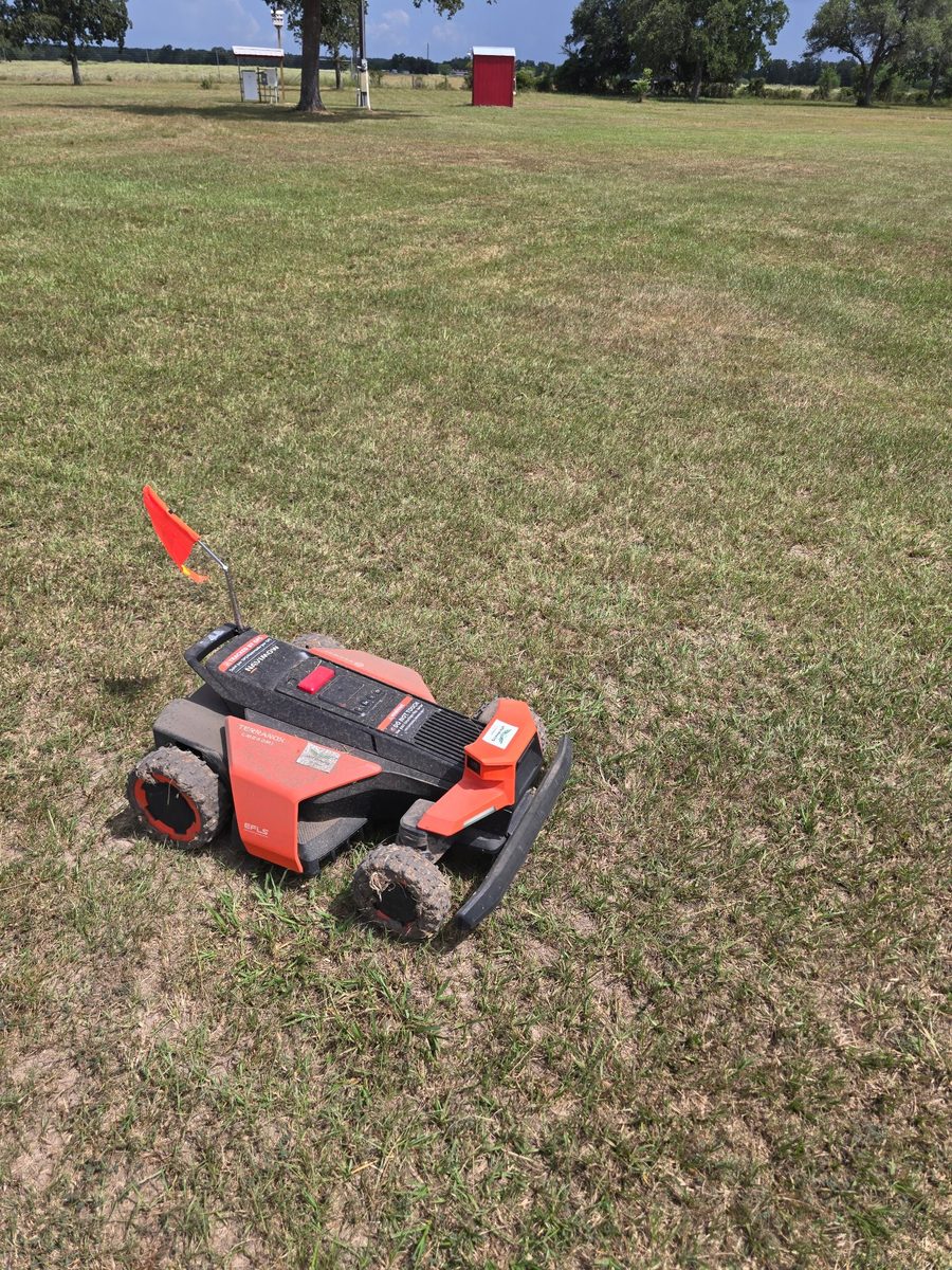 A mower and a runway marker flag on the Lavaca County strip